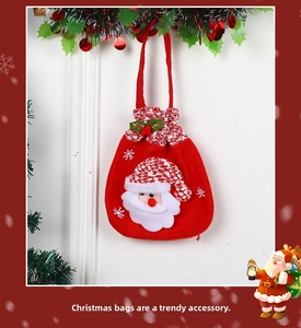 Detail of red Christmas candy bag with Santa Claus embroidery and drawstring closure