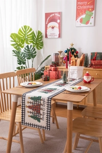 Detailed scene of Christmas table runner with Merry & Bright tree and plaid pattern