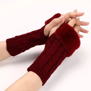 Close-up of wine red cable knit fingerless gloves with soft faux fur trim for winter warmth