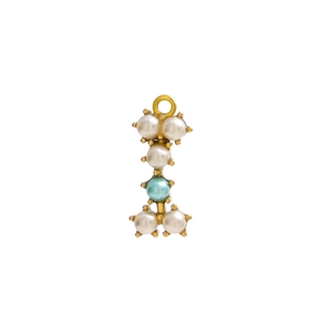 Macro shot of vertical letter I pendant with pearls and blue gemstone on golden base