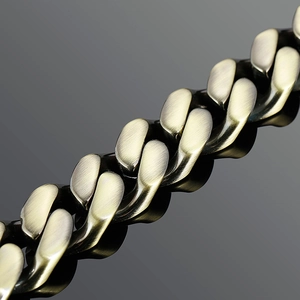 Macro view of men's Cuban link bracelet with vintage bronze brushed metal texture