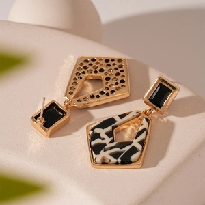 Vintage geometric gold earrings with black and white resin textures and silver needles