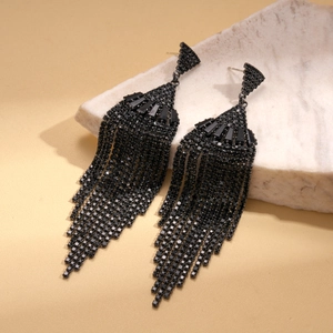 Dark style fan-shaped tassel earrings with black cubic zirconia on white marble base