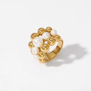 Gold triple-layer ring featuring polished beads and elegant white pearls on a wide band
