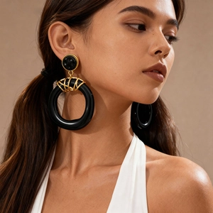 Chunky black resin hoop earrings with gold metal wrap detail for a retro look