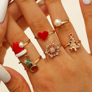 Detail of 6-piece Christmas ring set featuring reindeer and snowflake charms