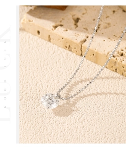 Detailed view of D color moissanite pendant with S925 silver ball chain on stone texture