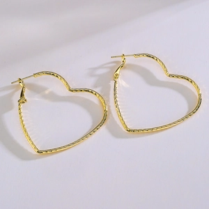 Chic twisted gold heart hoop earrings for women with elegant metallic textured finish
