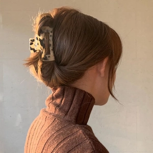 Rectangular tortoiseshell acetate hair claw clip shown on a model for a retro styling