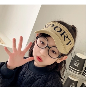 Close-up of kids knitted sun hat in khaki with SPORT embroidery and black round glasses