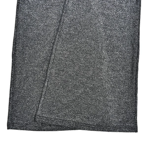 Macro shot of dark grey knit fabric with shimmer effect and flat overlock stitch hem