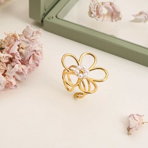 Bague fleur en perles dorées avec anneau ajustable sur un support à bijoux élégant