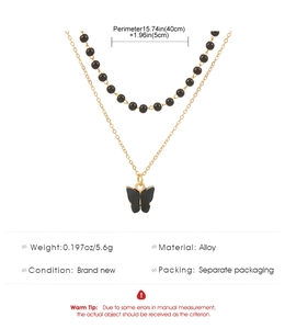 Detail view of double-layer Gothic necklace with black beads and butterfly pendant