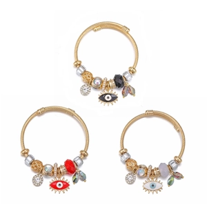 Detail of three gold evil eye bangles with enamel charms and crystal beads