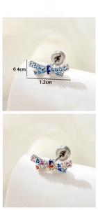 Detail view of 1.2cm silver bow earrings with colorful zircon stones in blue and pink