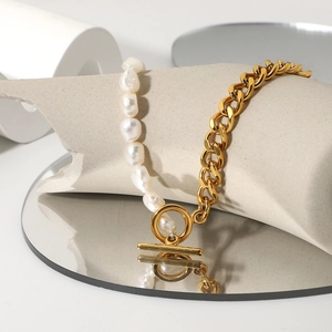 Golden Cuban chain and freshwater pearl necklace with OT toggle clasp on a mirror