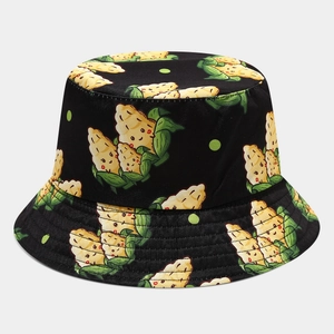 Detail of black reversible bucket hat featuring cute cartoon corn and green polka dots