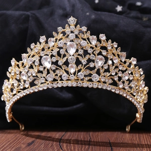 Macro detail of luxury bridal crown with intricate gold alloy vine and teardrop crystals