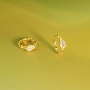 Close-up of gold S925 silver hoop earrings with water drop zircon and chain texture