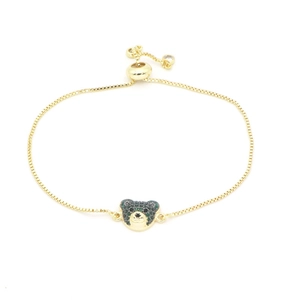 Adjustable golden box chain bracelet featuring a green zircon bear head charm on white background