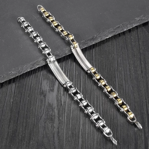 Close-up of stainless steel bike chain bracelets in silver and gold two-tone finish