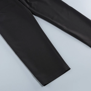 Detail of premium black suit trousers featuring smooth fabric texture and elegant drape