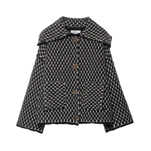 Women's black and white knit jacket with wide lapel and retro buttons on white background