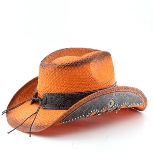 Detail of western straw cowboy hat featuring embossed leather band and metallic rivets