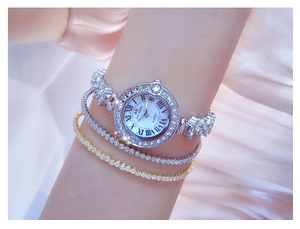 Close-up of sparkling rhinestone ladies watch and tennis bracelets on a silk background