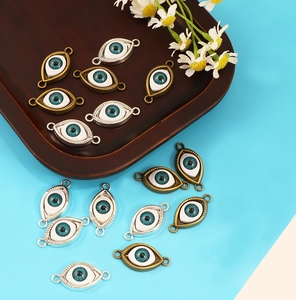 Detailed view of bronze and silver evil eye charms for bracelet and necklace making