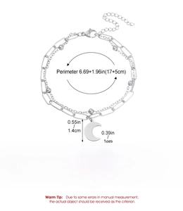 Detail of silver double-layered stainless steel chain bracelet with moon pendant