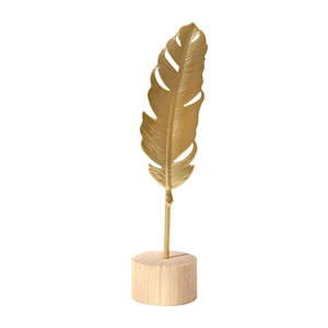 Modern gold hollow feather sculpture on a wooden base for luxury home shelf decor