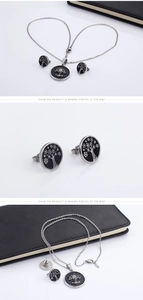 Macro shot of stainless steel Tree of Life pendant and earrings set with black inlay