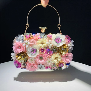 Detail of luxury evening clutch bag featuring handmade floral beads and sparkling sequins