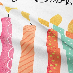 Close-up detail of Happy Birthday tapestry showing colorful candle patterns and fabric texture