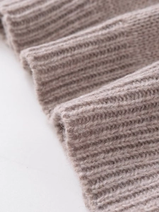 Close-up of thick beige ribbed knit wool fabric showing soft texture and premium warmth