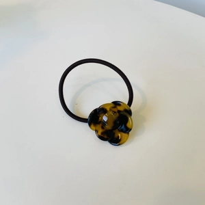 Amber tortoiseshell camellia flower elastic hair tie on white background for high ponytail