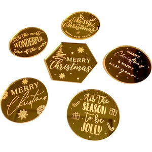 Set of 6 gold mirror acrylic Christmas cake toppers with festive holiday engravings
