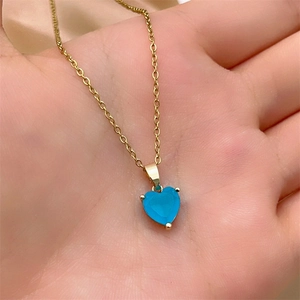 Detailed view of sky blue heart zircon pendant on a gold plated stainless steel chain
