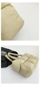 Detail of quilted square padding on lightweight puffer tote bag in beige finish