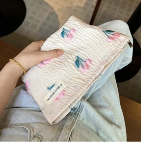 Close-up of canvas makeup bag with pink cherry pattern and high-quality gold zipper
