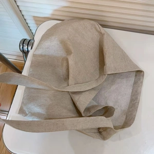 Close-up of beige canvas tote bag showing soft natural fabric texture and dual straps