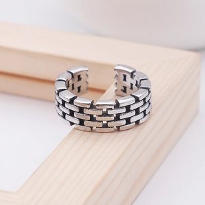 Macro detail of silver open ring featuring a unique brick wall texture and adjustable band