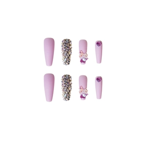 Lavender press-on nails with full rhinestones, bows, and purple heart gemstones
