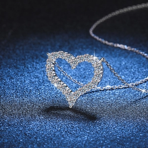Sparkling S925 sterling silver heart-shaped moissanite pendant necklace on dark background