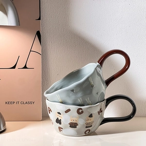 Detail of stacked ceramic mugs featuring cute rabbit and pig patterns with handles