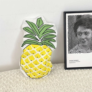 Creative pineapple plush cushion on white sherpa texture for modern home decor