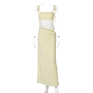 Detail of light yellow sleeveless dress with lace patchwork and waist cut-out design