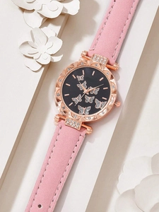 Close-up of a pink velvet strap watch with rose gold case and butterfly dial accents