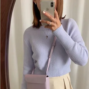 Mirror selfie showing a lavender knit sweater with matching crossbody bag and silver jewelry